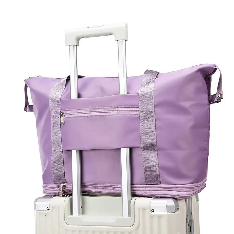 Lavender duffle bag with reinforced sides and an upright wheeled handle opening