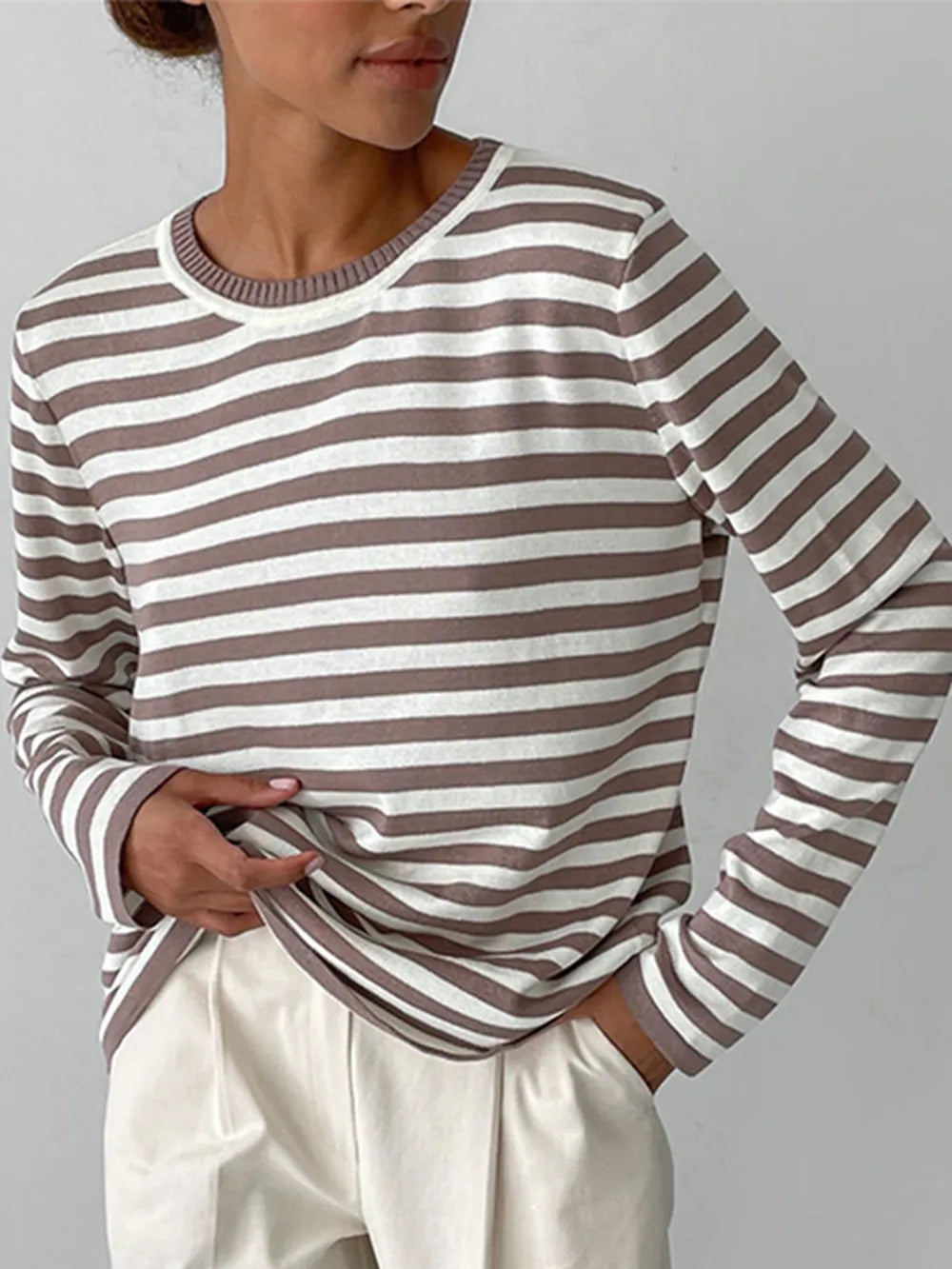 Striped long-sleeve sweater with round neck, mocha and white horizontal stripes.