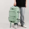 Large mint green travel backpack with front zip pockets and side straps, top handle.