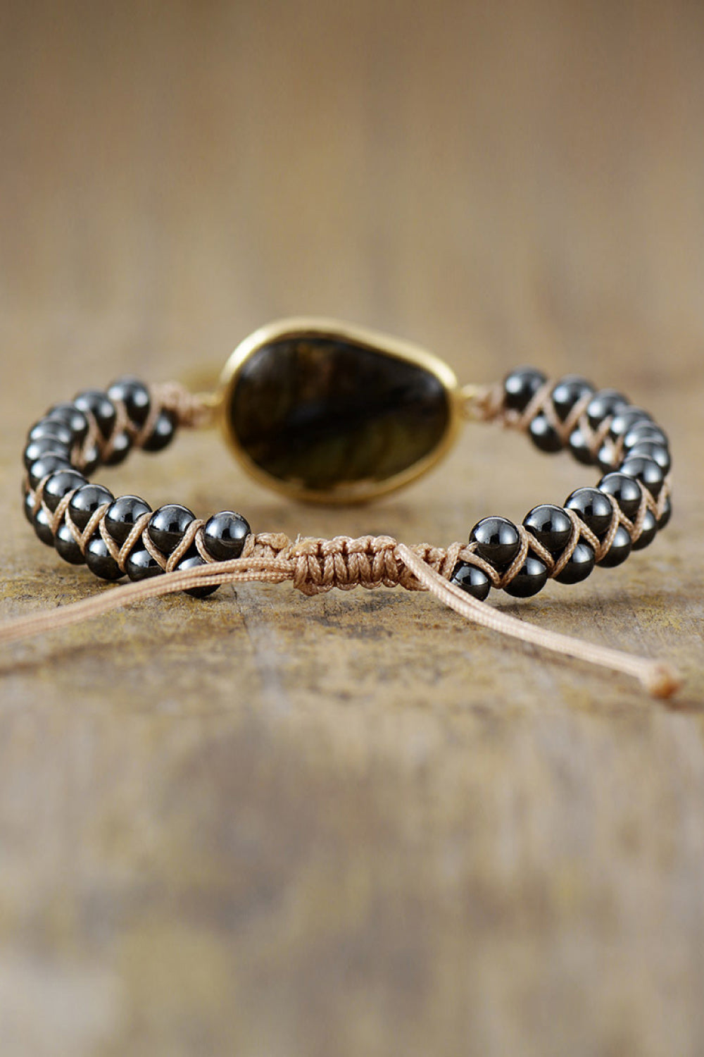 Black beaded bracelet with oval labradorite stone and twisted rope clasp detail