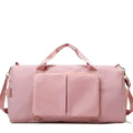 Large travel duffel bag with front zip pocket, pale pink body and top carry handles