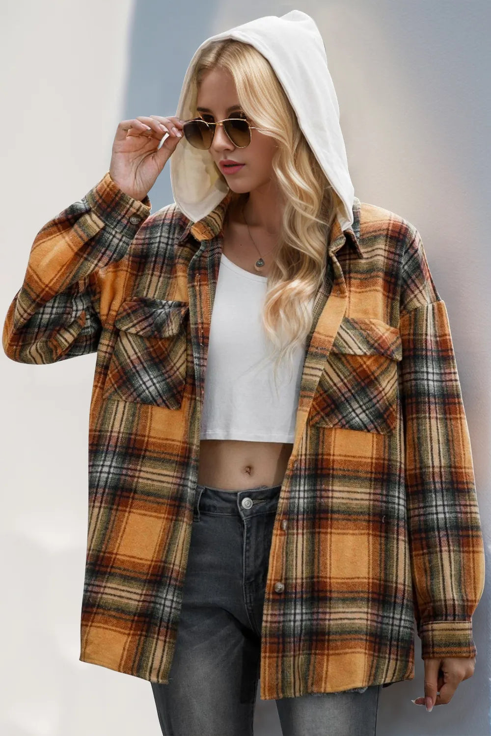 Orange plaid hooded shacket with drawstring, front button placket and long sleeves