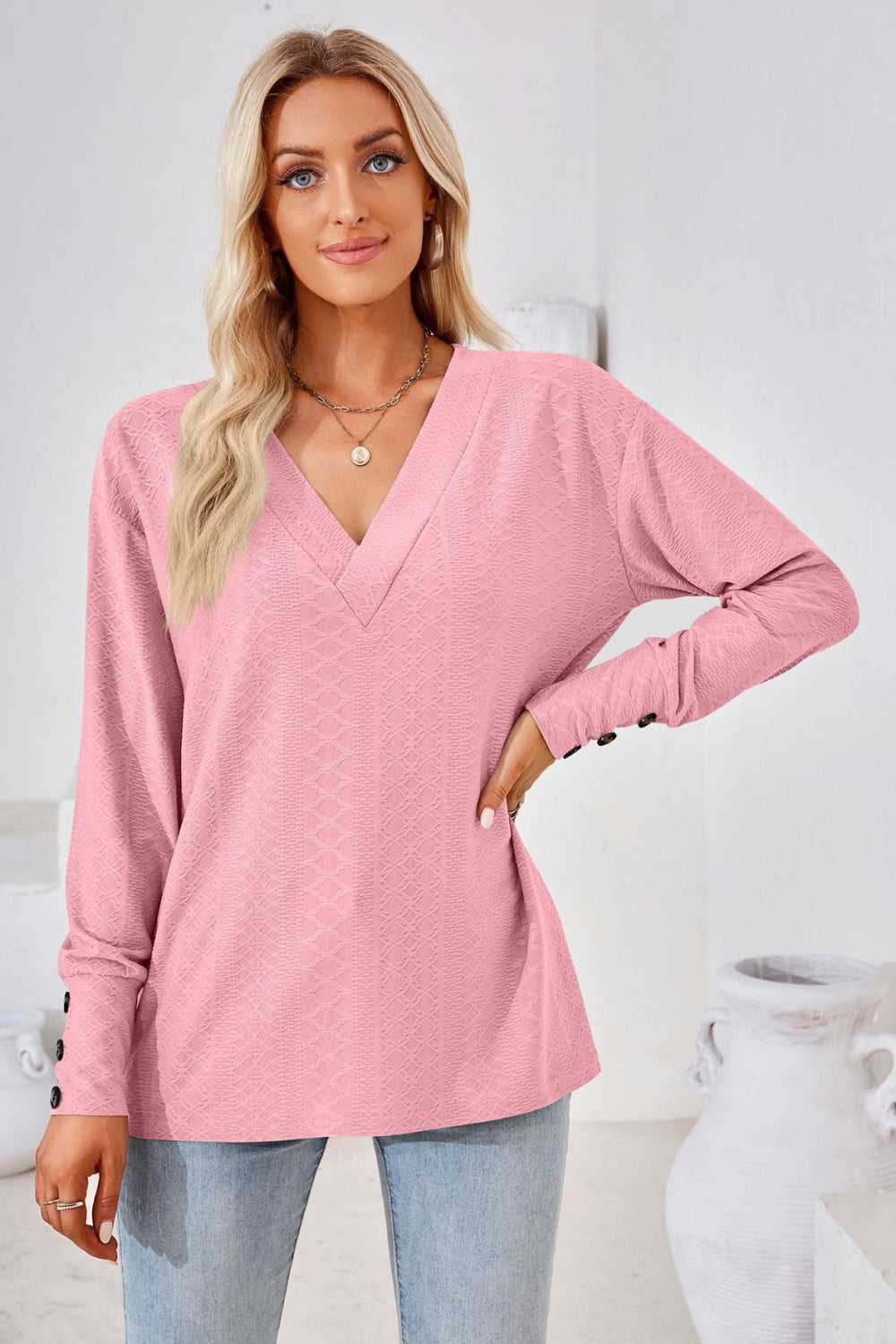 Dusty pink V-neck long-sleeve blouse with textured diamond pattern and relaxed fit