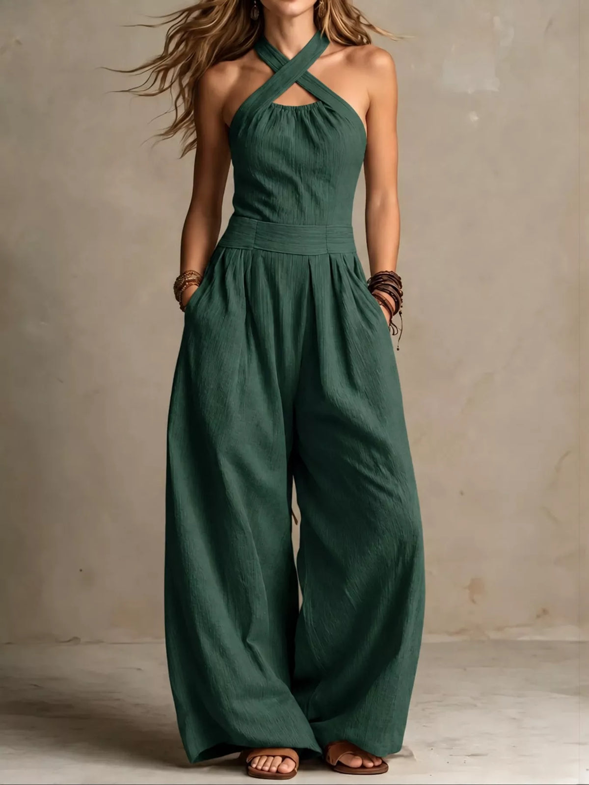 Dark green linen halter jumpsuit with high waist and wide-leg trousers