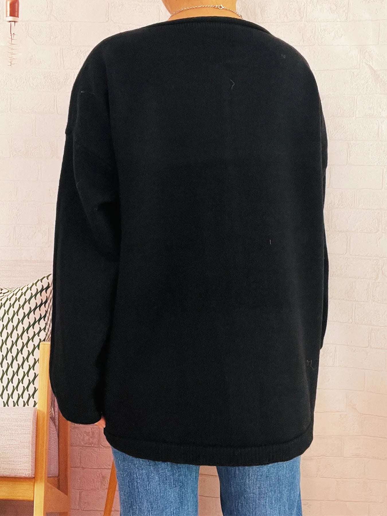 Black one-button drop-shoulder cardigan with crew neckline and long sleeves