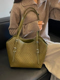 Green textured woven tote bag with dual handles and front zip pocket