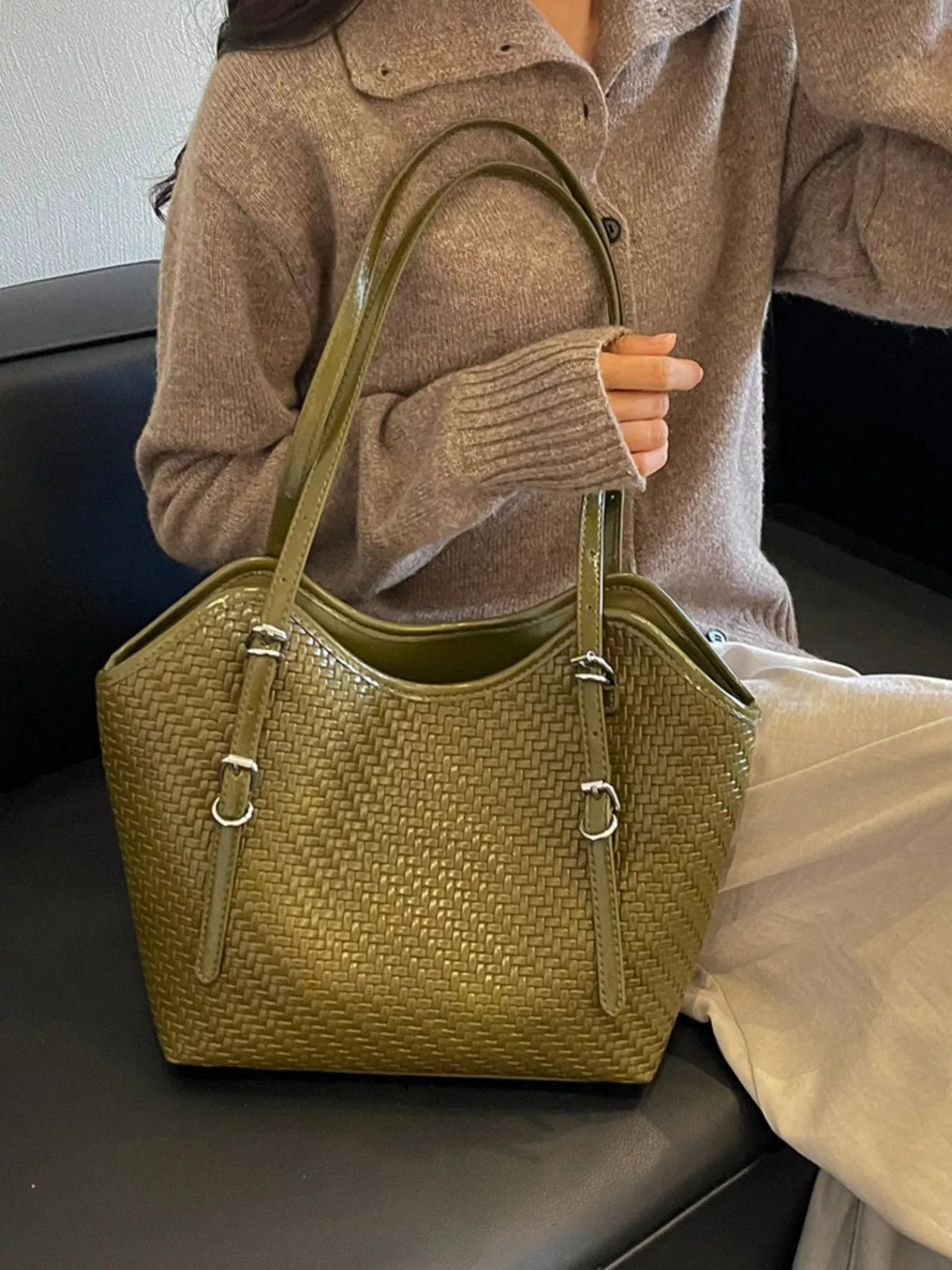 Green textured woven tote bag with dual handles and front zip pocket