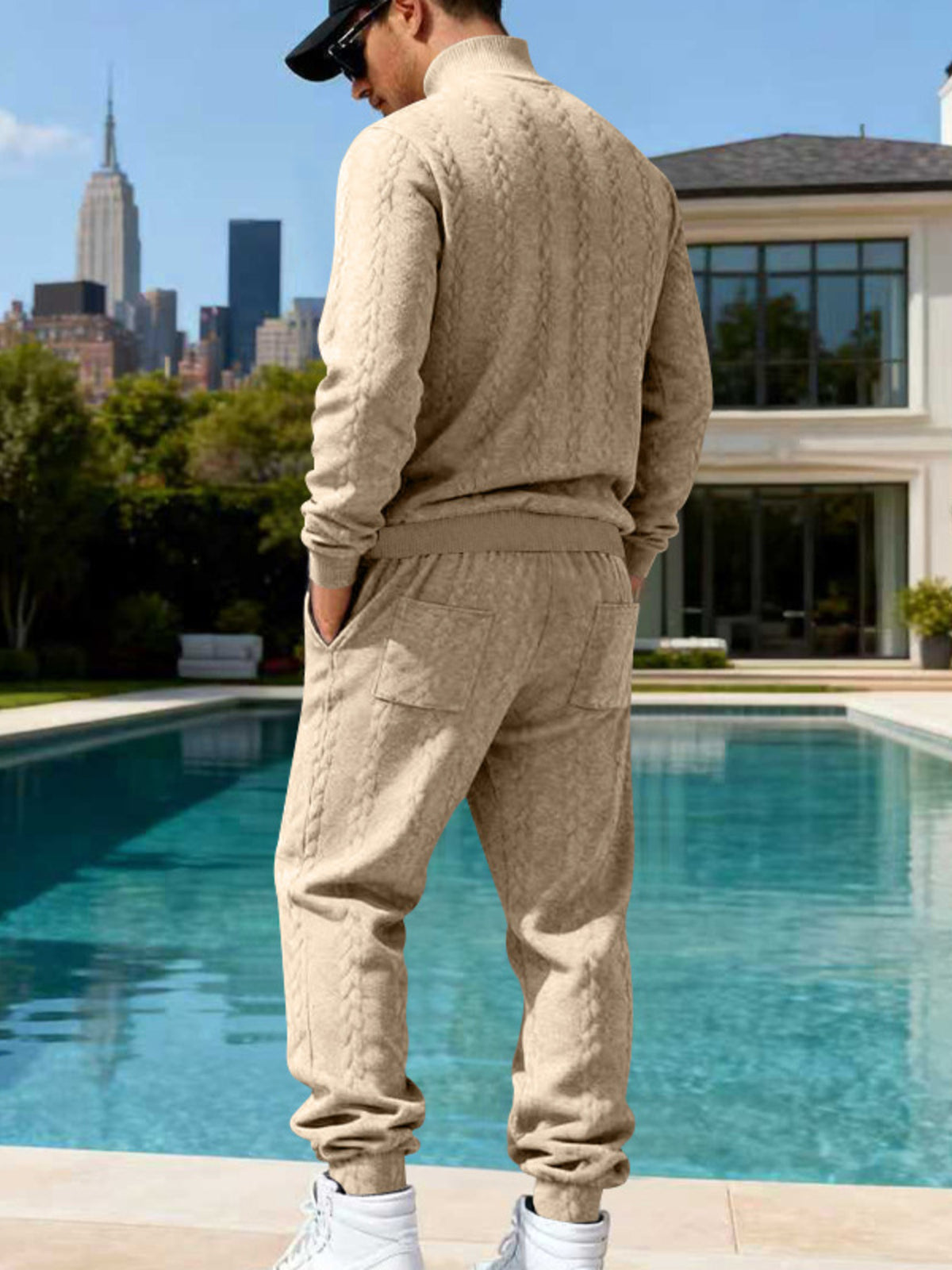 Men's light gray cable knit mock neck sweater and matching jogger pants, back view