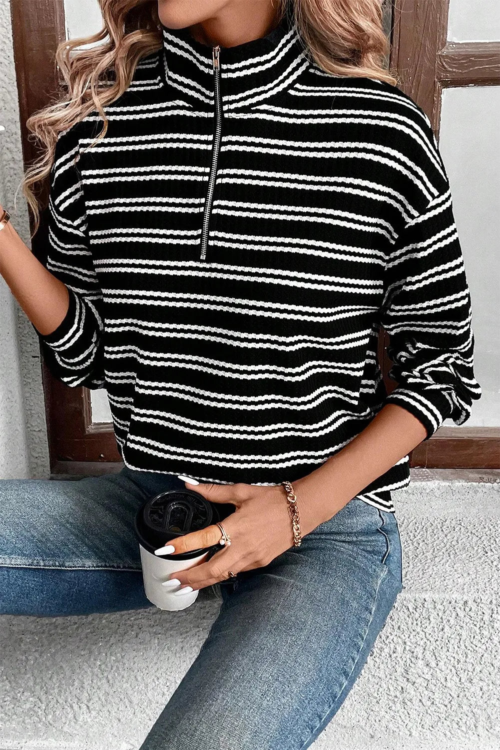Black-and-white striped half-zip long sleeve top with zip placket