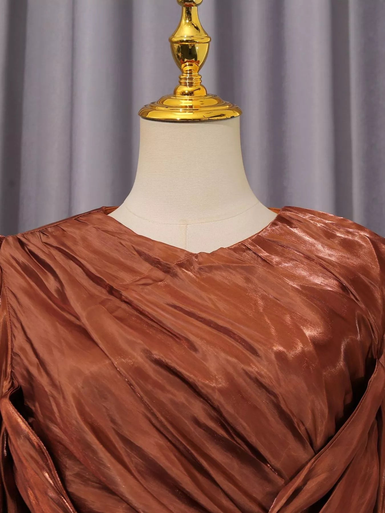 Cedar & Moore Front Twisted Draped Long Sleeve Maxi Dress in copper satin-look fabric on mannequin