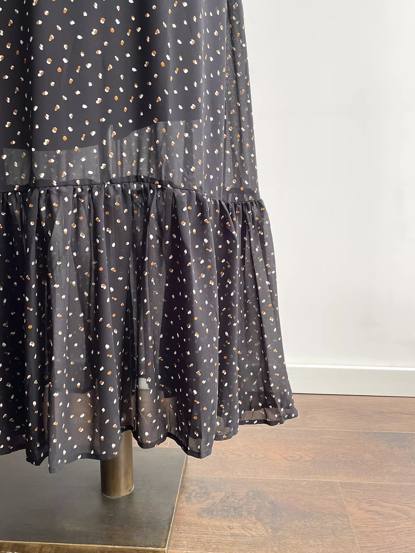 Black polka dot maxi dress with tiered ruffle hem and gathered skirt detail