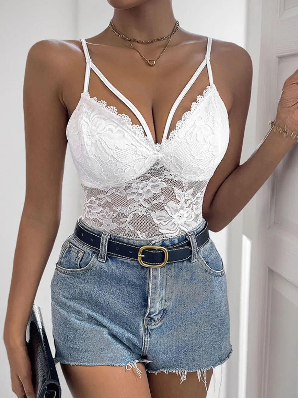 White lace spaghetti strap bodysuit with deep V-neck and floral cups