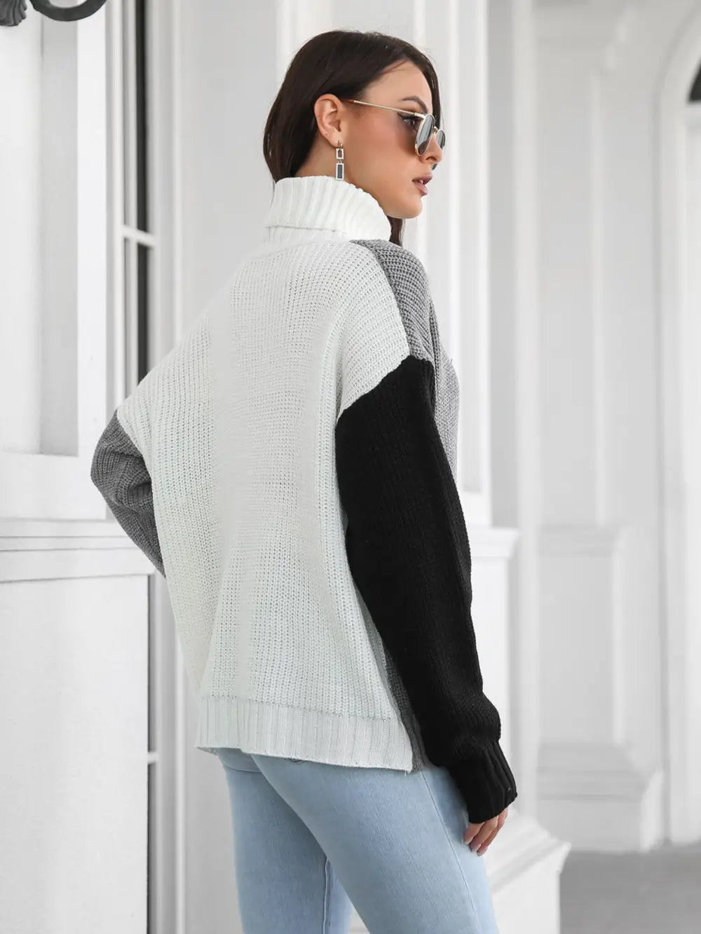 Color-block turtleneck sweater, back view, long sleeves with ribbed hem, gray and black.
