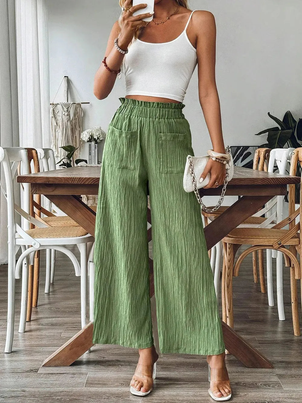 Green wide-leg pants with elastic waist and front patch pockets, relaxed fit