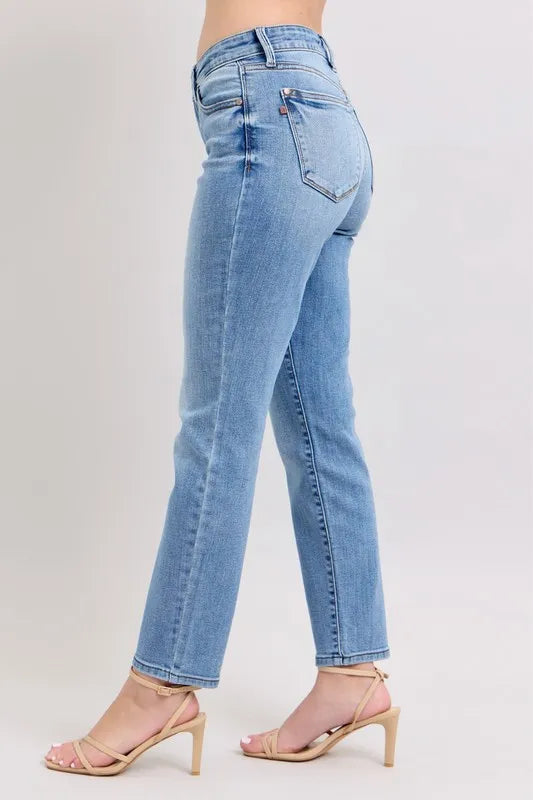 Light blue slim jeans from the side view with rear pocket and cuffed cropped ankle hem