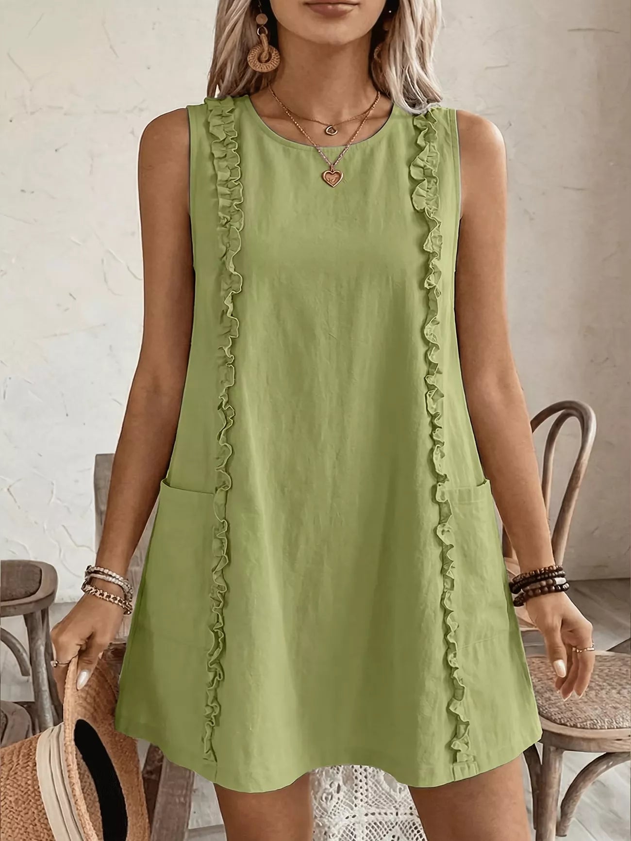Cedar & Moore Frill Sleeveless Round Neck Dress in light green with ruffle trim and pockets.