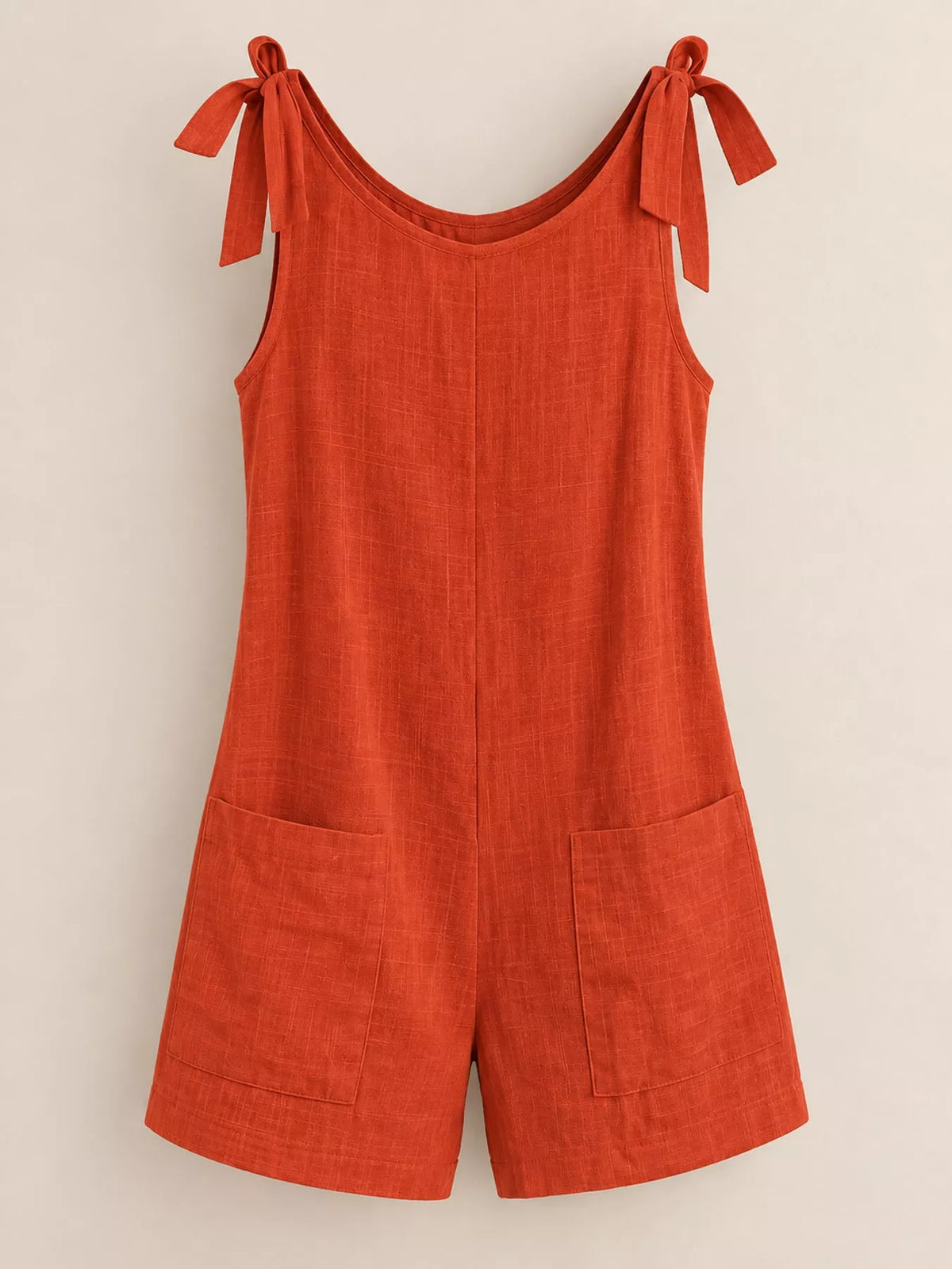 Rust red tie-shoulder bow romper with front pockets and wide-leg shorts