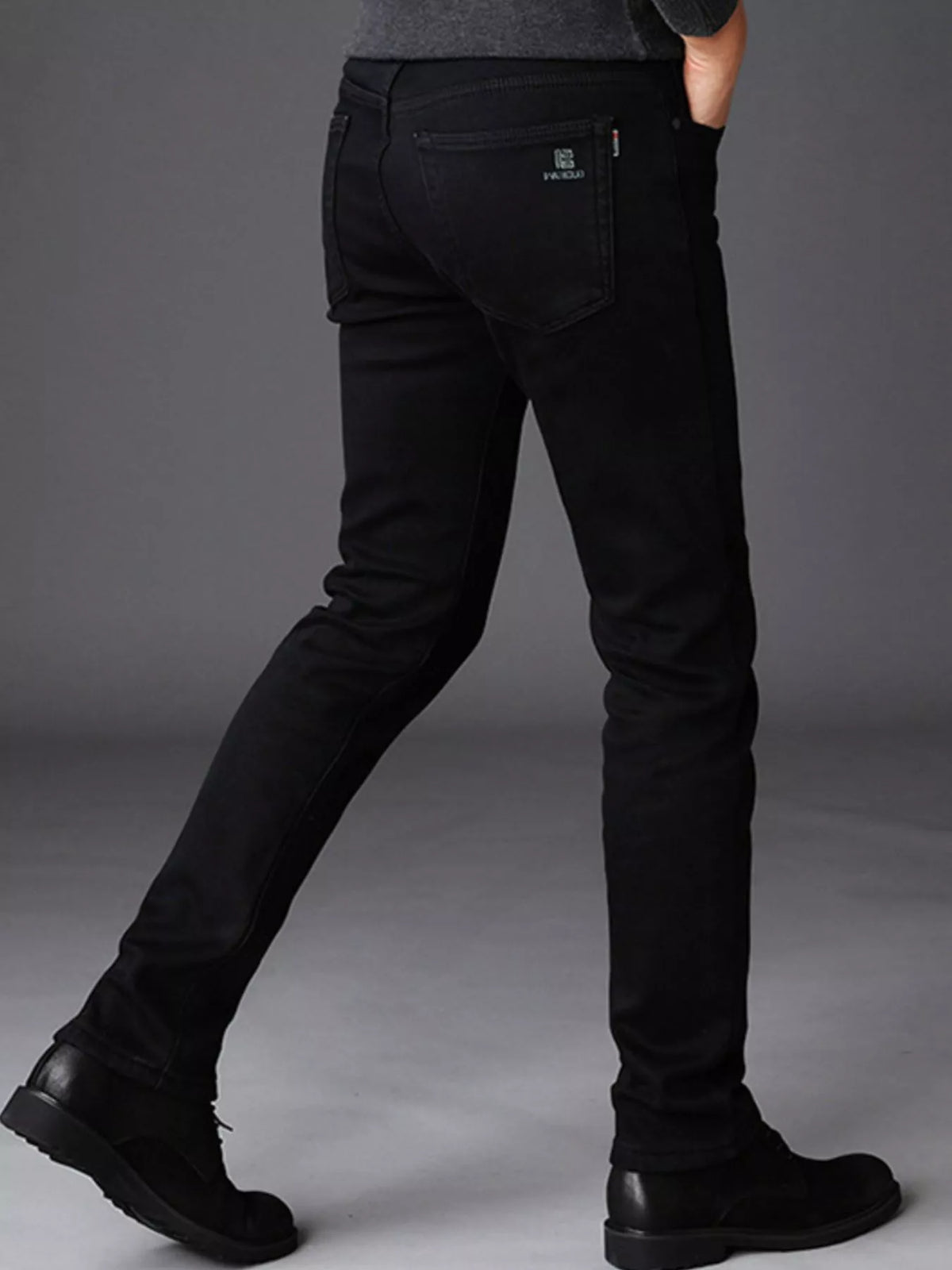 Black slim-fit stretch cotton jeans, detailed front pockets and zip fly, clean seam lines