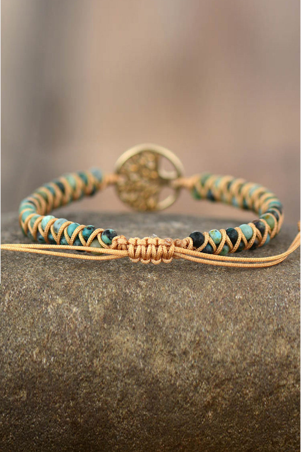 Handmade beaded bracelet with braided turquoise and orange cord, gold round charm at back