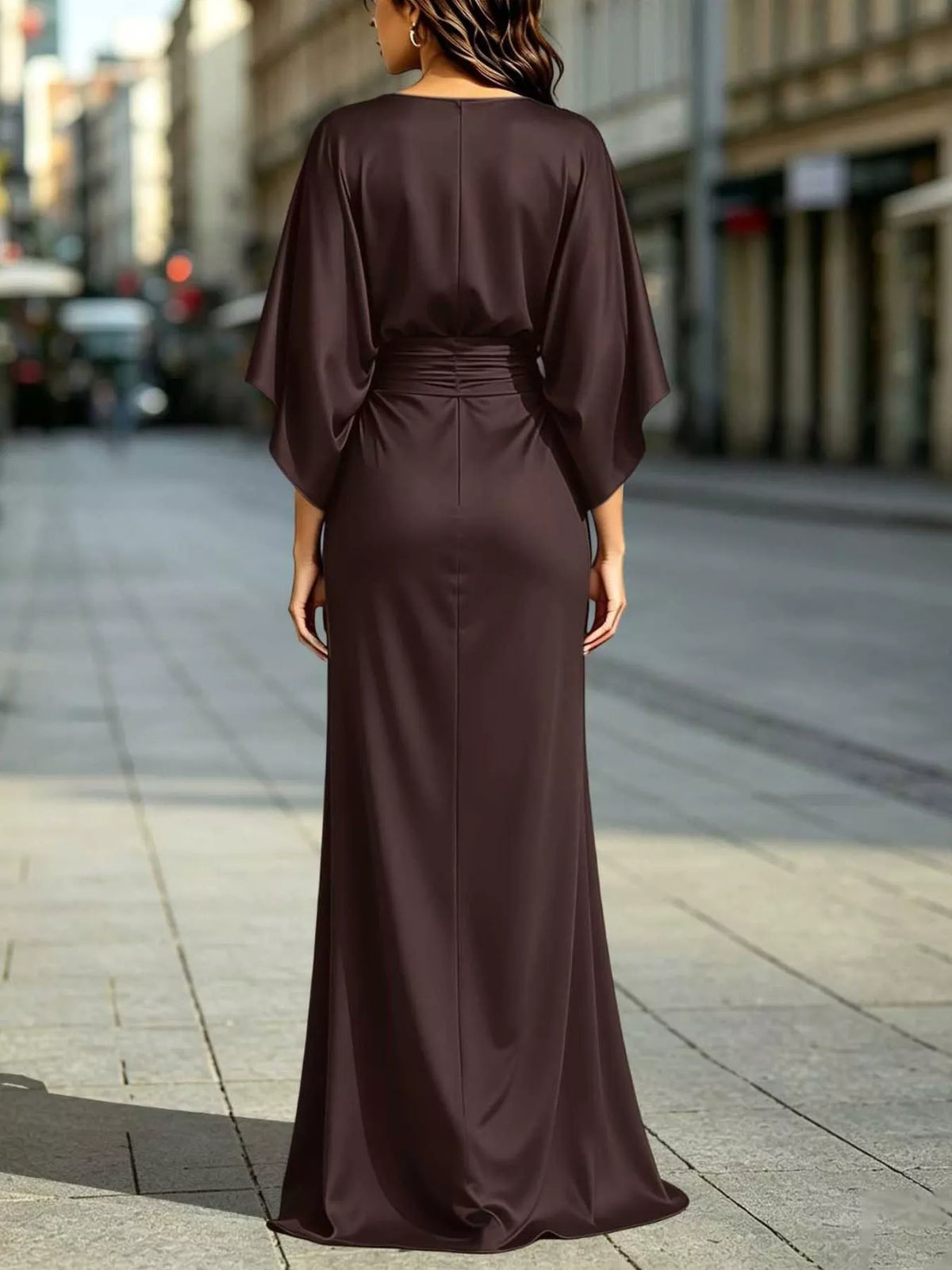 Back view of ruched waist maxi dress with draped dolman sleeves and front slit, dark plum