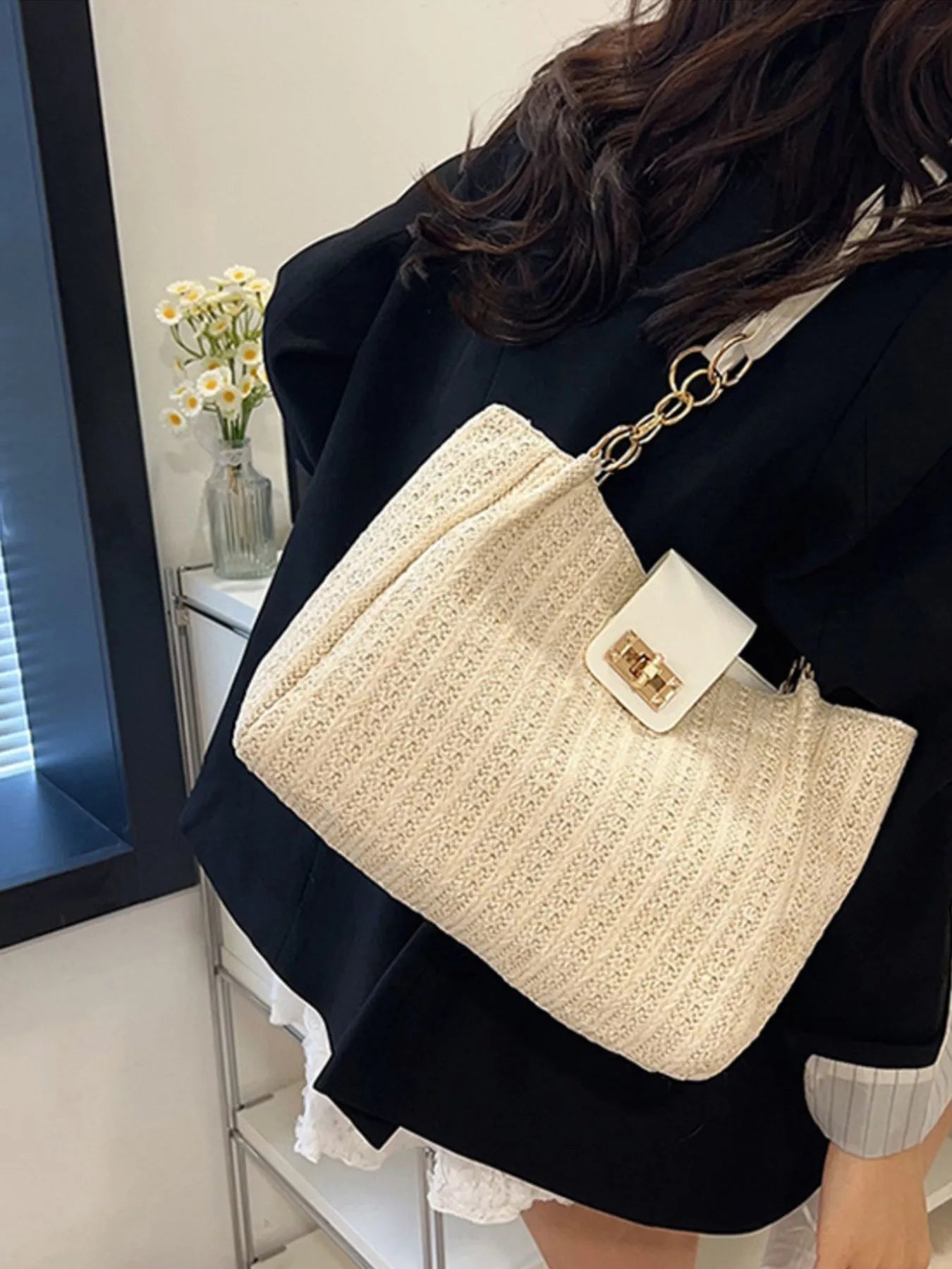 Beige woven straw shoulder bag with gold chain strap and white front clasp