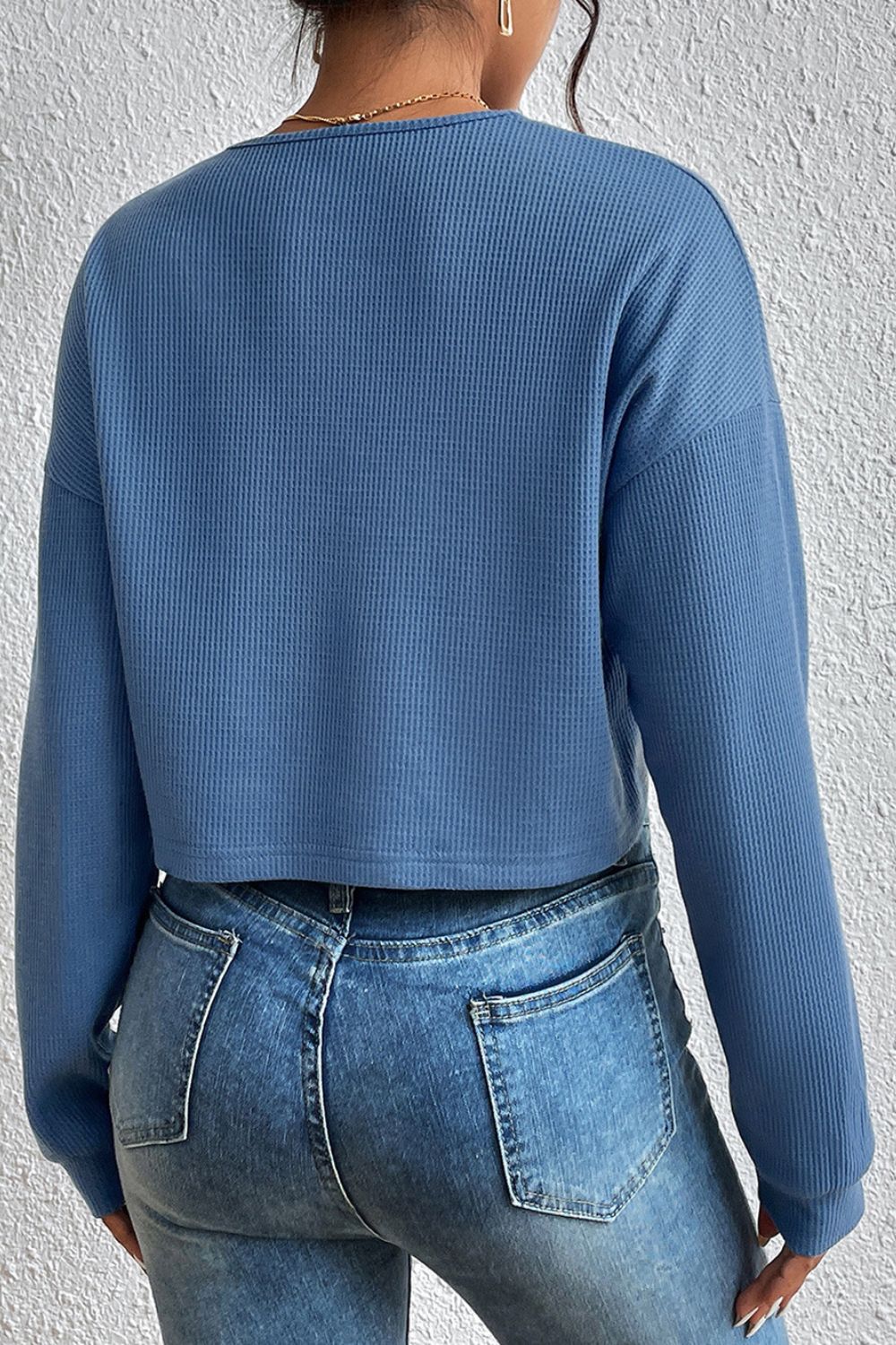 Dusty blue cropped button-front V-neck raglan sleeve blouse, back view