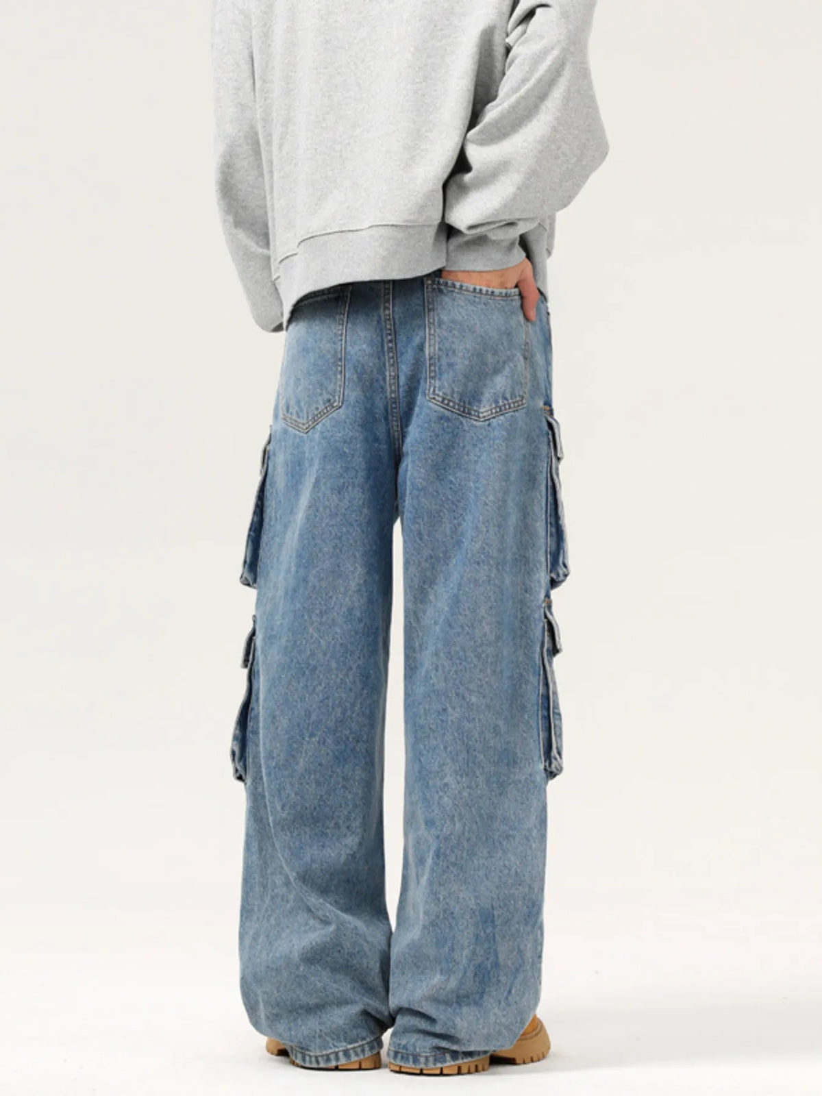Blue washed cargo jeans with tall cargo side pockets and loose straight leg