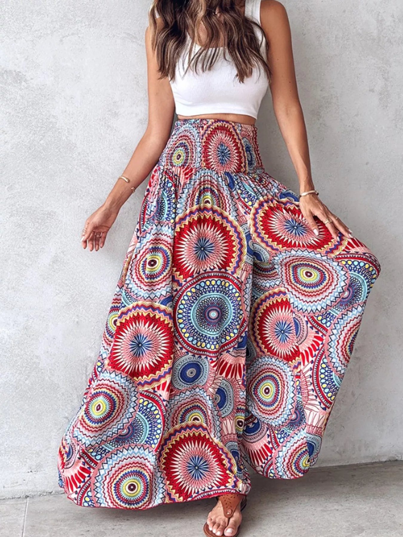 Colorful printed wide-leg pants with circular mandala pattern in red, blue, and yellow