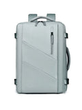 Light blue canvas backpack bag with top handle, front diagonal panel, and zip pocket