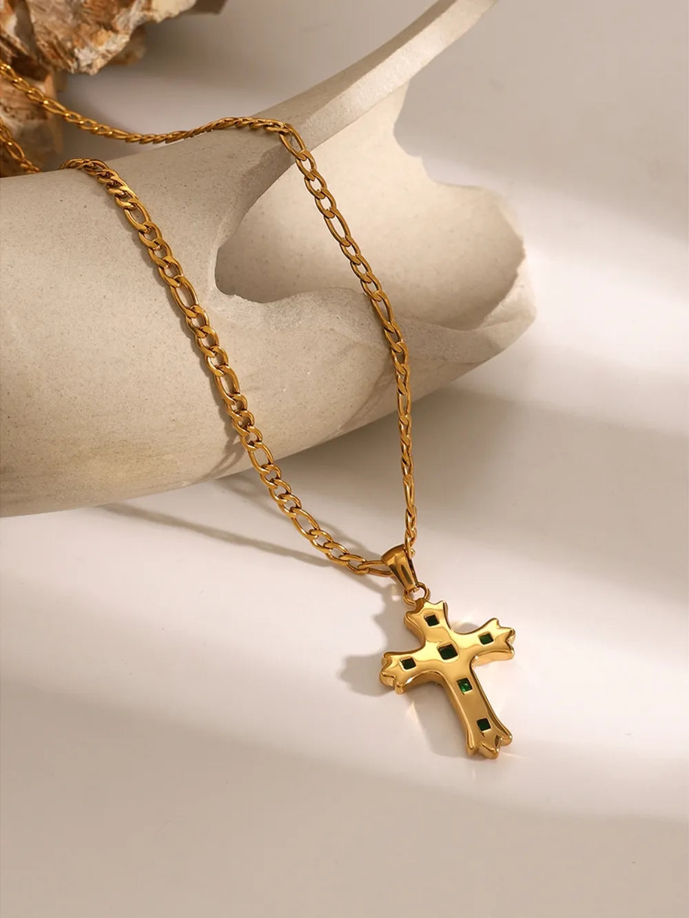 Gold-tone cross pendant necklace with green and clear stone inlays