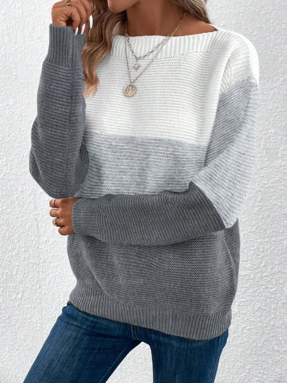 Color-block boat neck sweater in white and gray with long sleeves and ribbed hem.