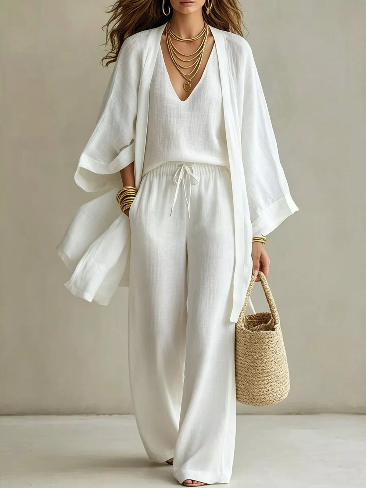 White three-piece set with V-neck top, drawstring wide-leg pants, and open cardigan
