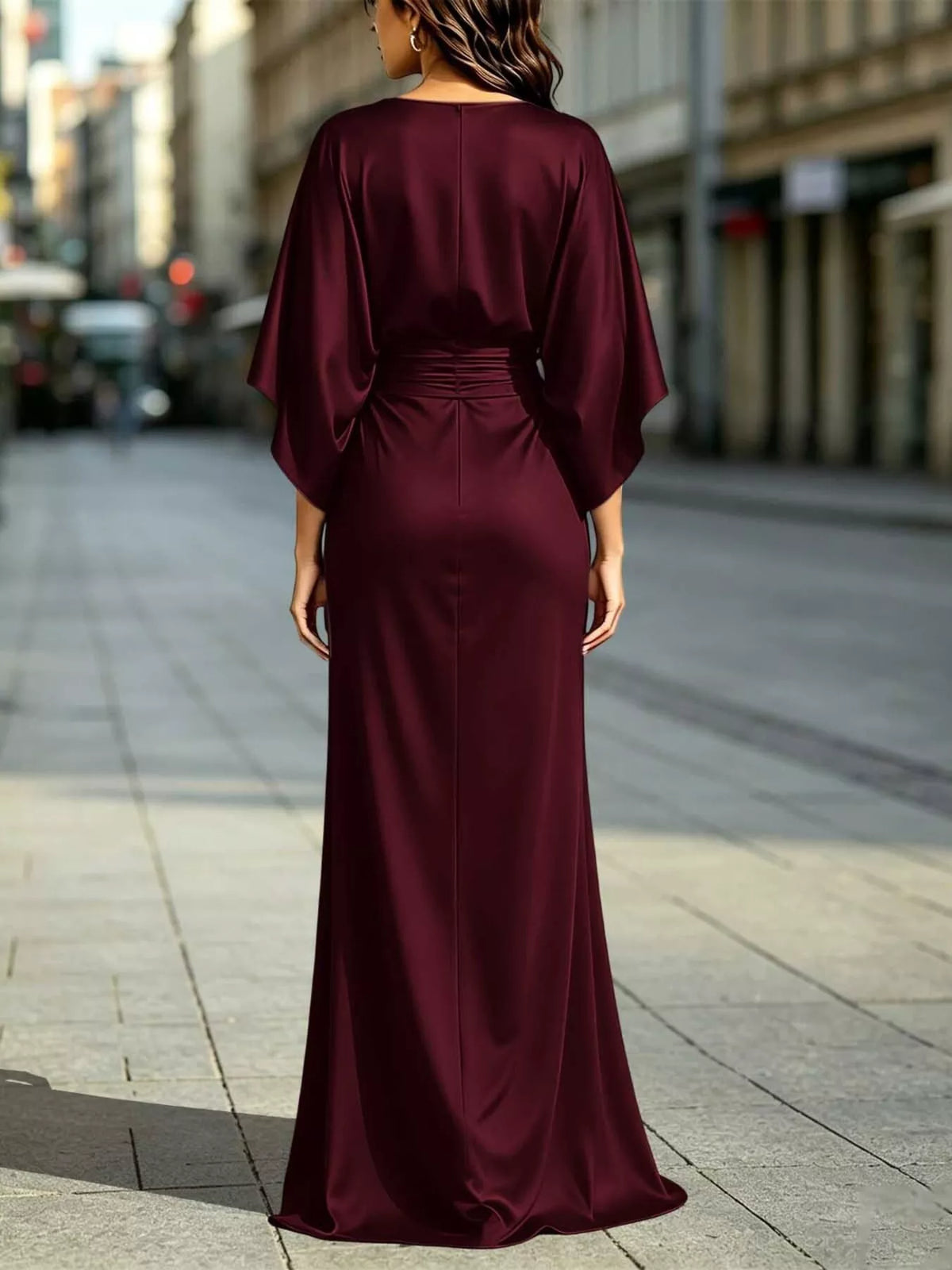 Back view of burgundy satin maxi dress with ruched waist and draped sleeves