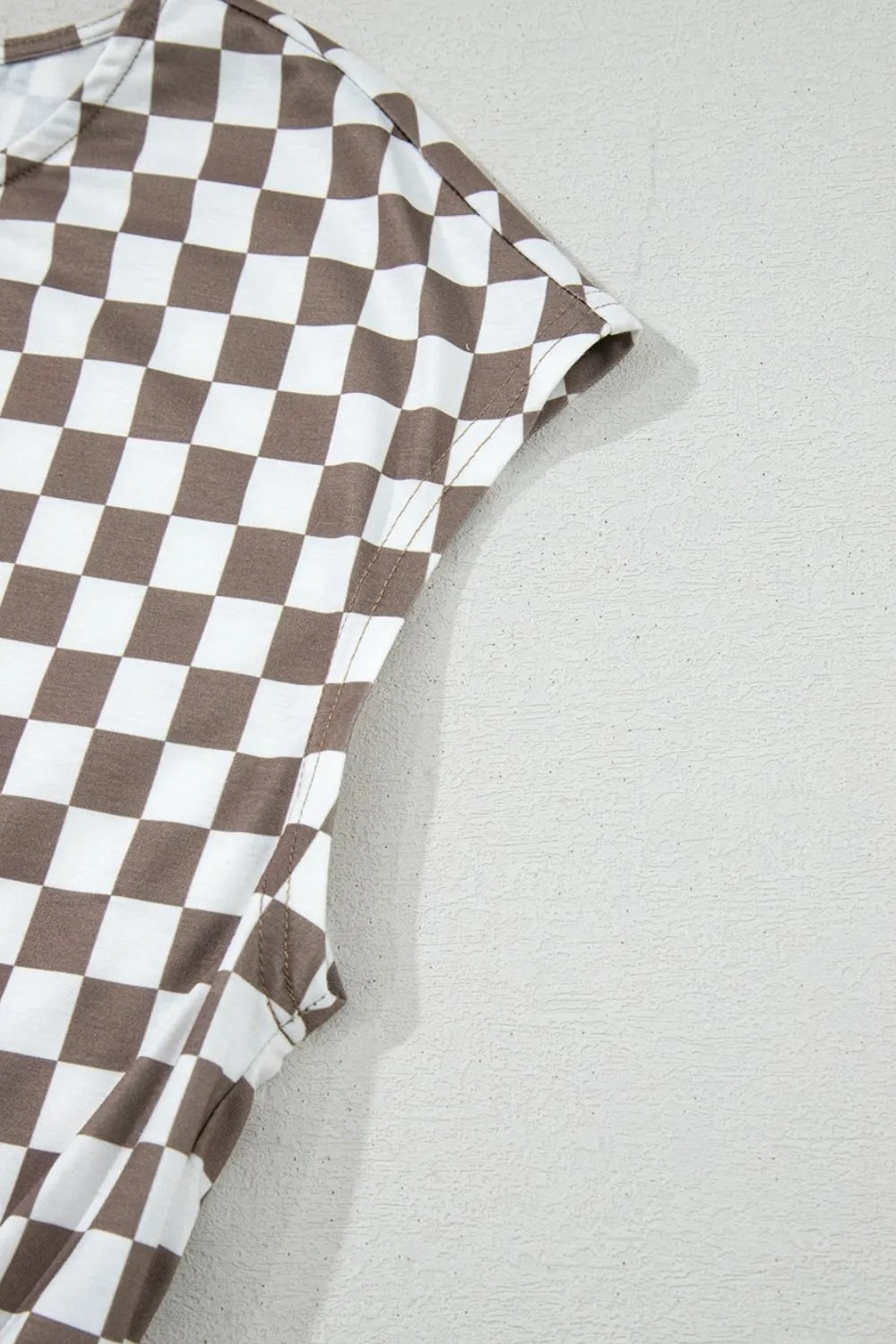 Brown-and-white checkered sleeveless jumpsuit with wide-leg silhouette