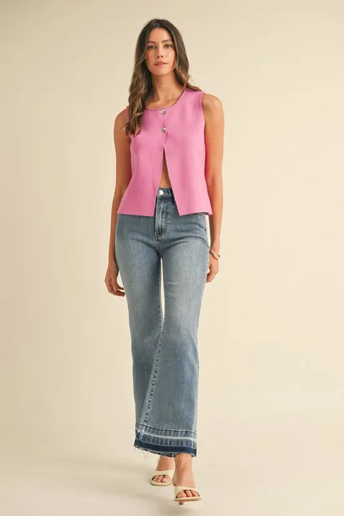 Pink crop sweater vest with sleeveless cut and metal button front detail
