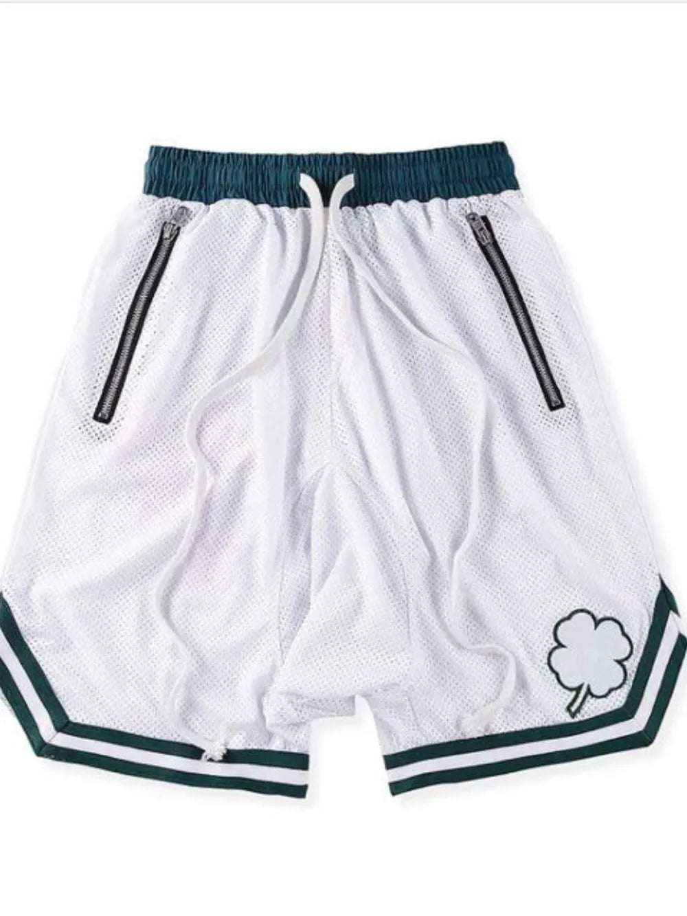 White mesh-style drawstring shorts with green trim, side zipper pockets, and clover patch