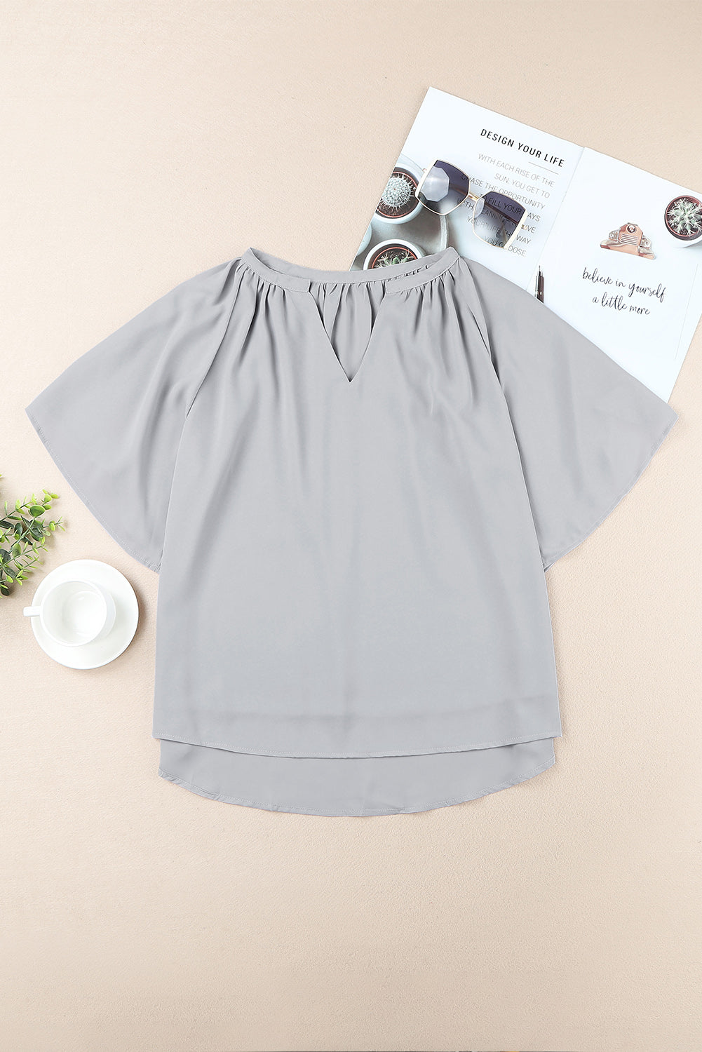 Gray flutter sleeve top with gathered notch neckline and keyhole back