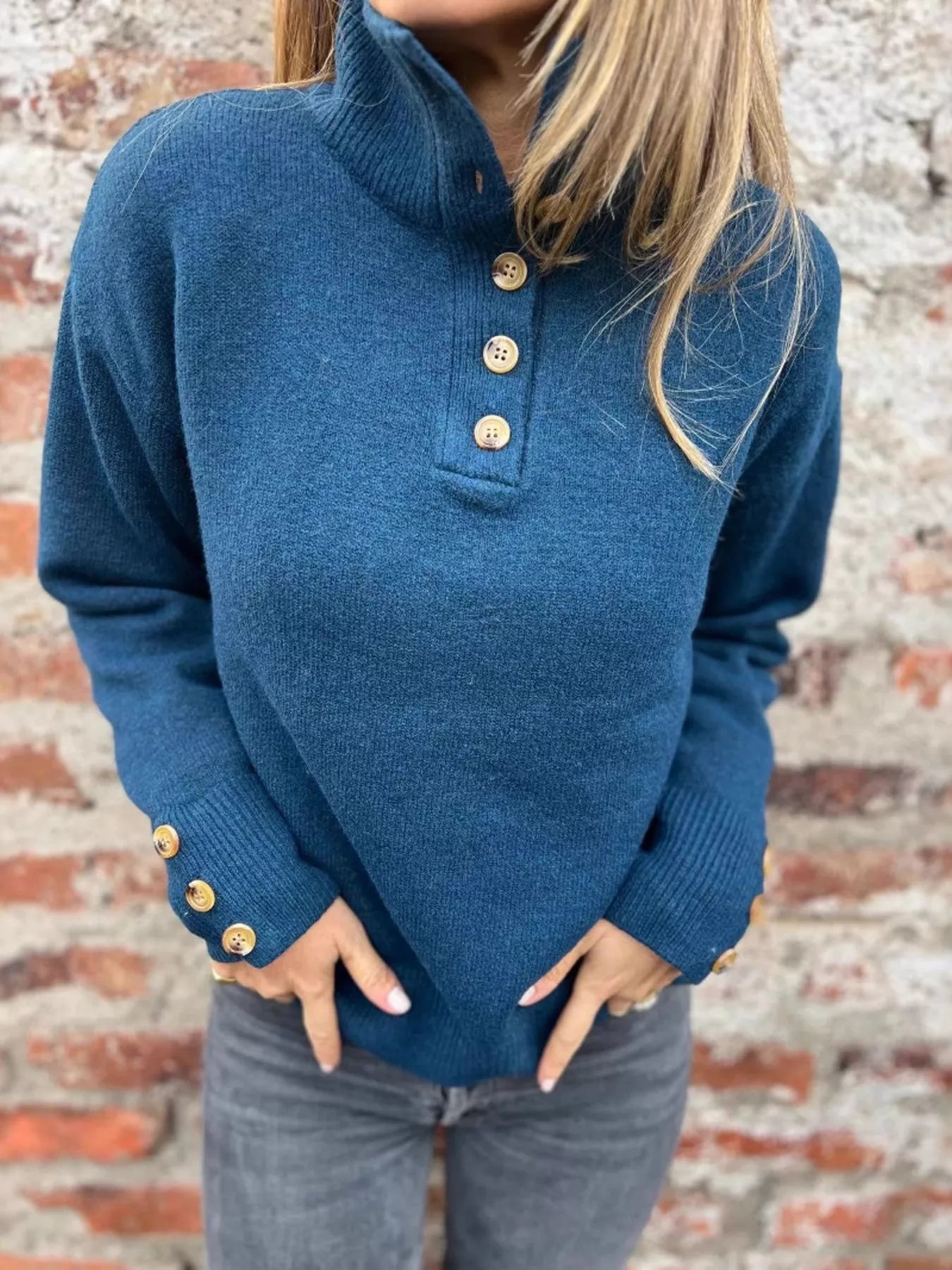Blue turtleneck sweater with three-button placket and long sleeves