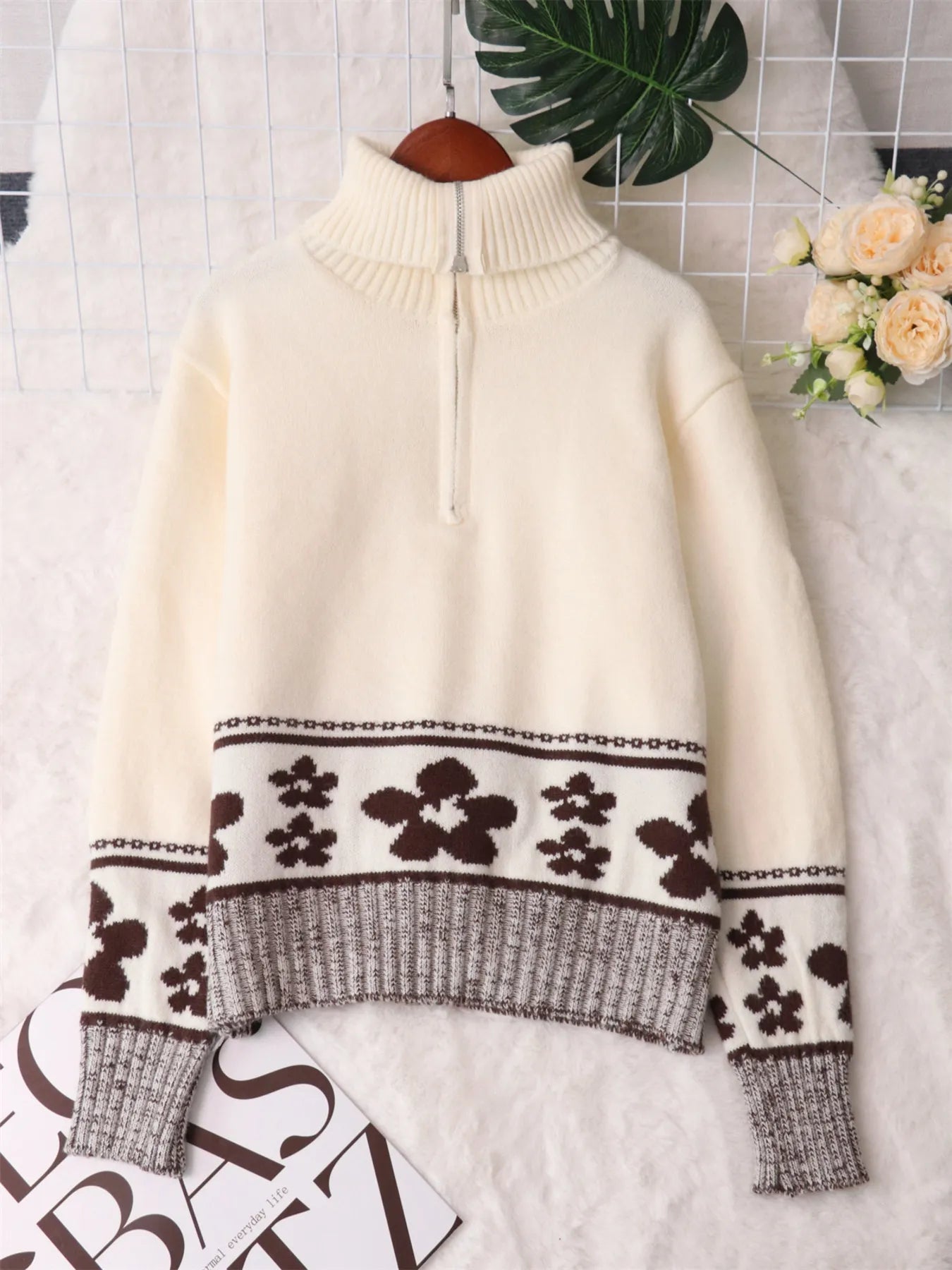 Cream mock turtleneck sweater with half-zip and black flower knit band detail