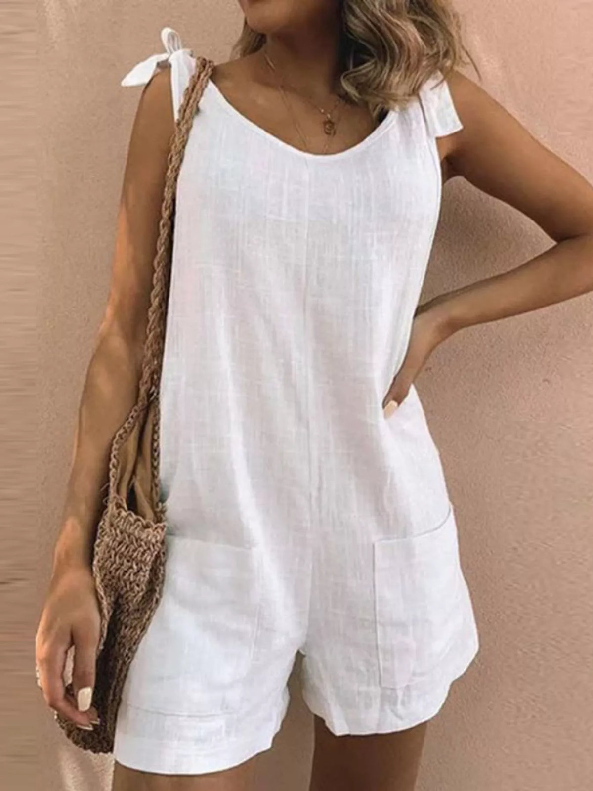 White tie-shoulder bow romper with pocketed shorts and scoop neckline