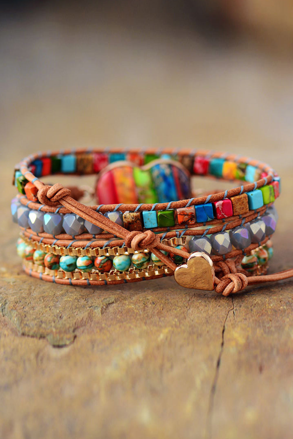 Layered beaded bracelet with heart emblem, braided leather tie, and colorful bead rows