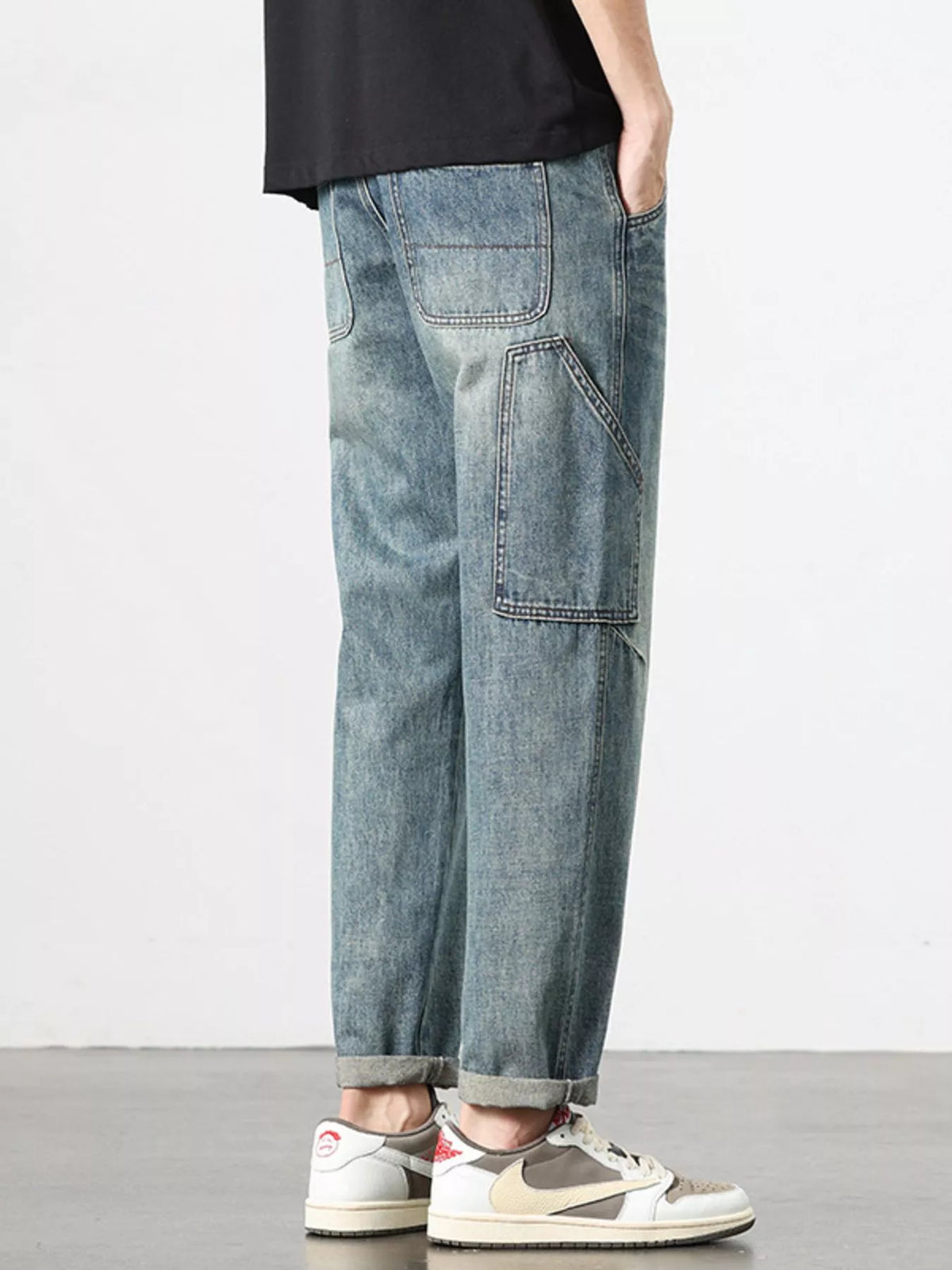 Relaxed washed blue jeans with back patch pockets and cuffed straight-leg hem.