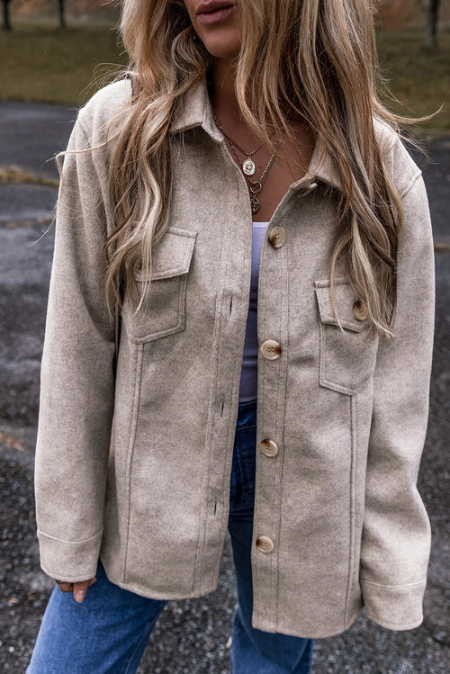 Dust Storm button-up collared jacket with flap pockets and long sleeves.