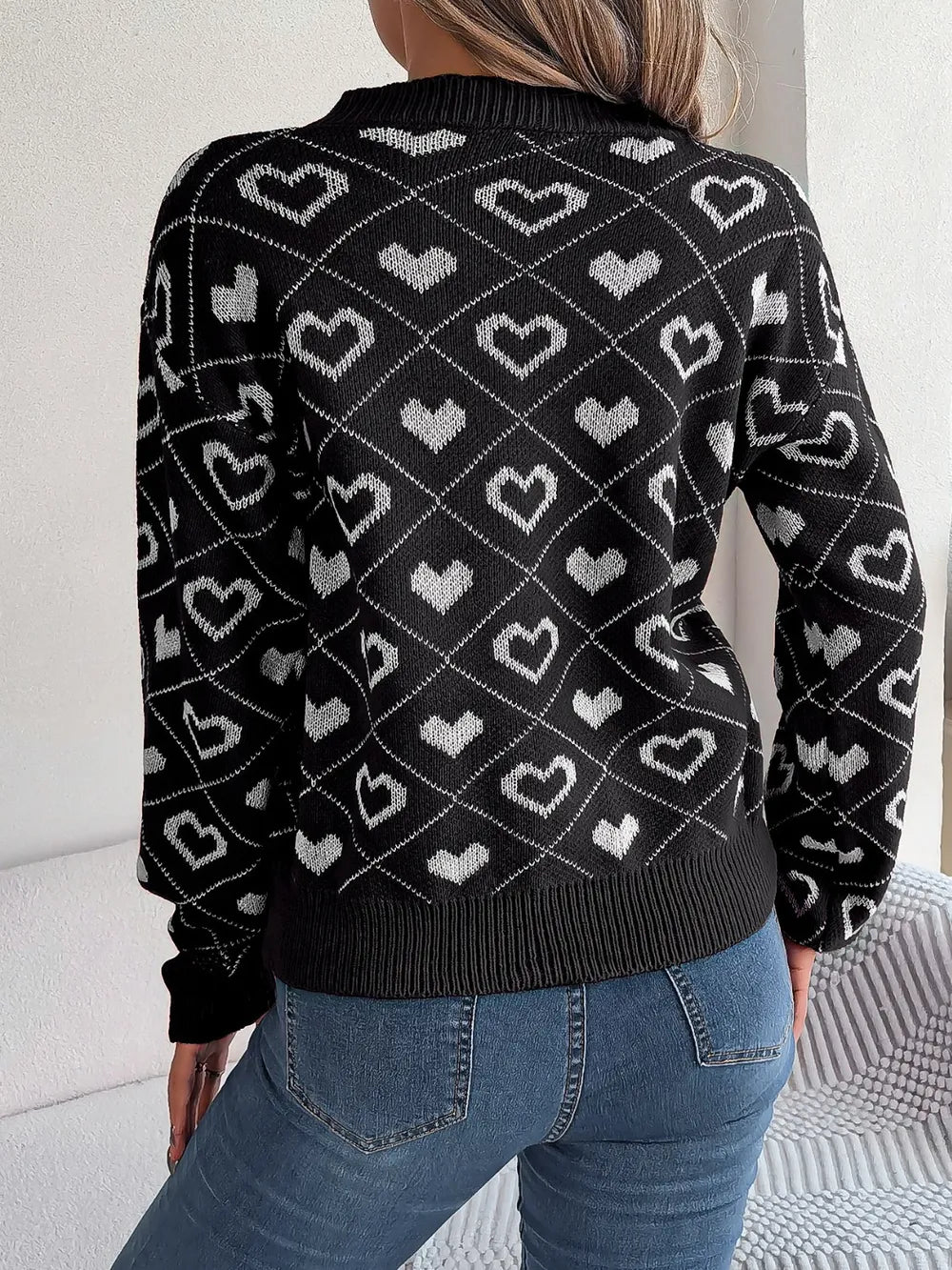 Black heart-pattern knit V-neck sweater, back view, ribbed hem and cuffs