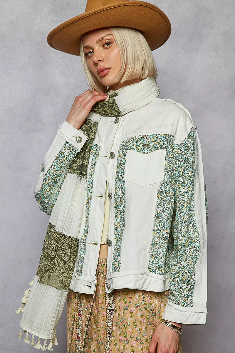 Off-white patchwork denim jacket with green floral patchwork, button front, fringe hem