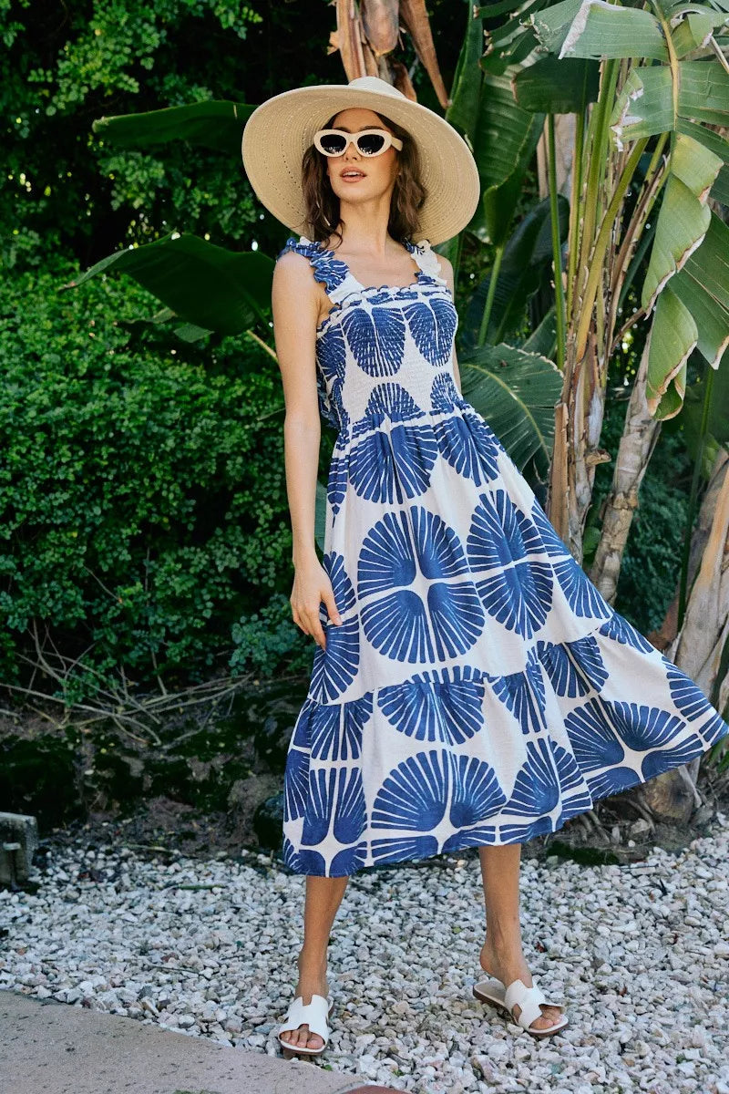 Sleeveless smocked bodice midi dress with navy abstract print and tiered hem on white