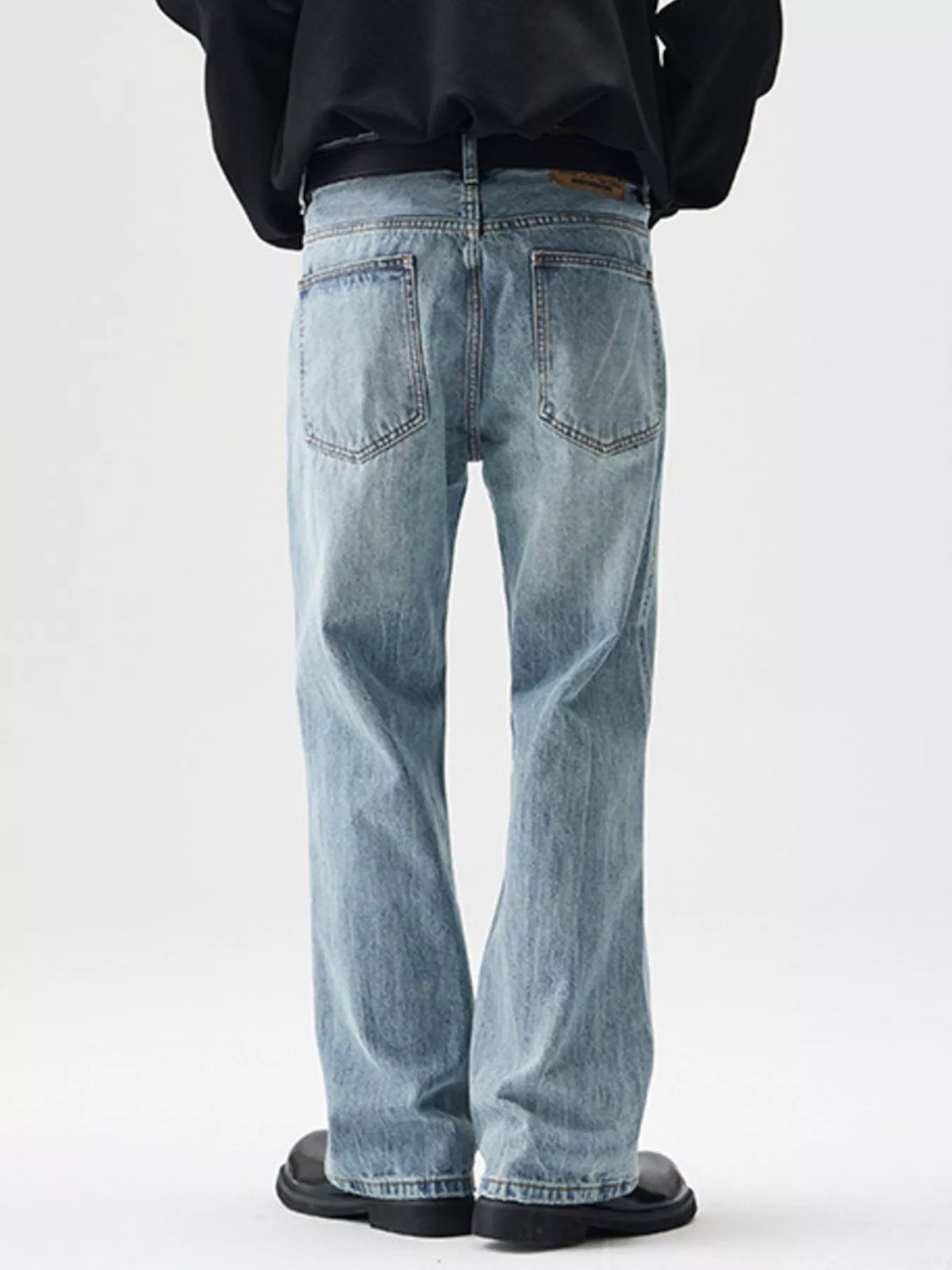 Washed stretch relaxed cotton jeans, light blue, back view with patch pockets