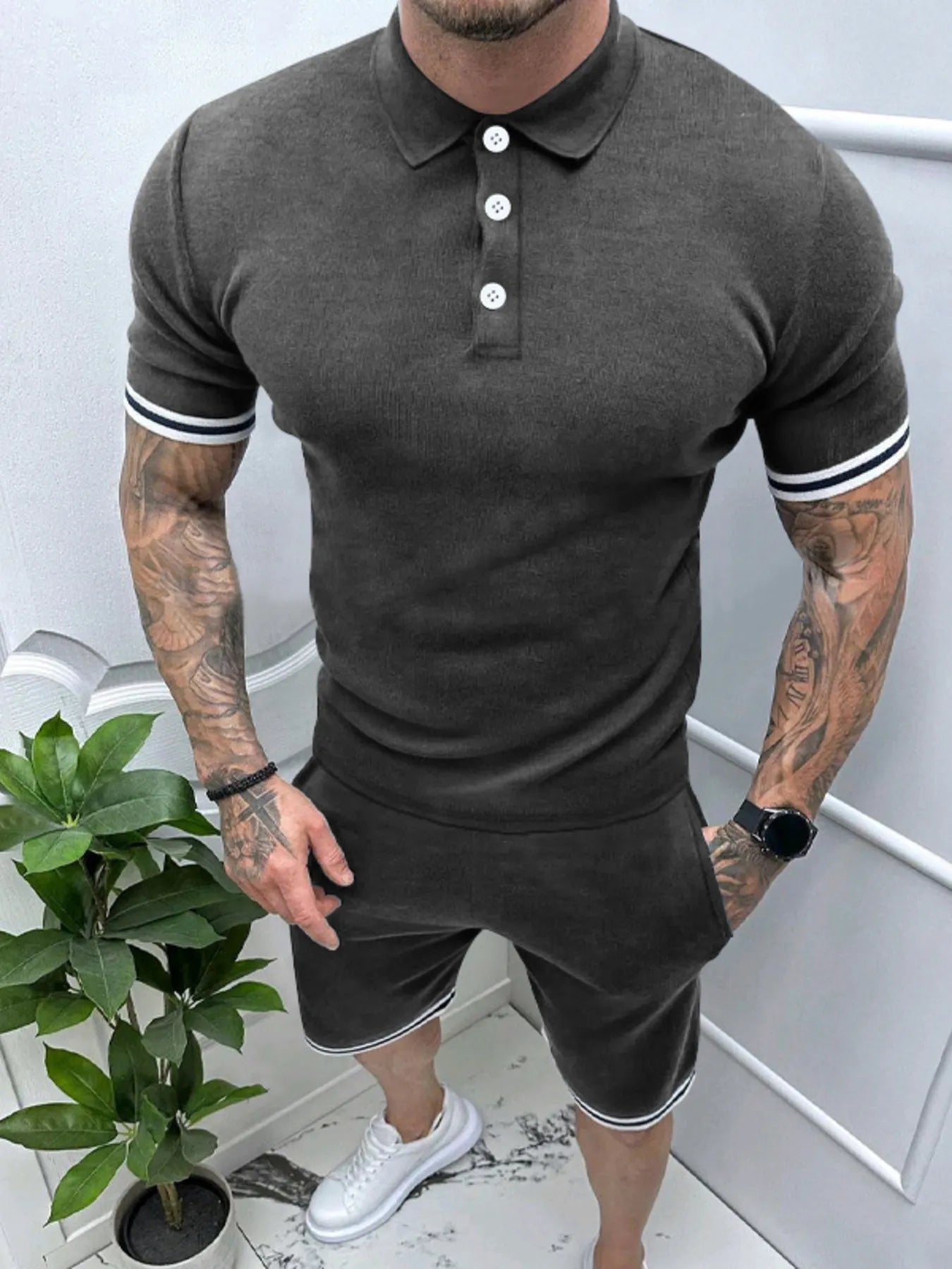 Men's dark gray polo and shorts set with striped sleeve cuffs, button placket and drawstring.