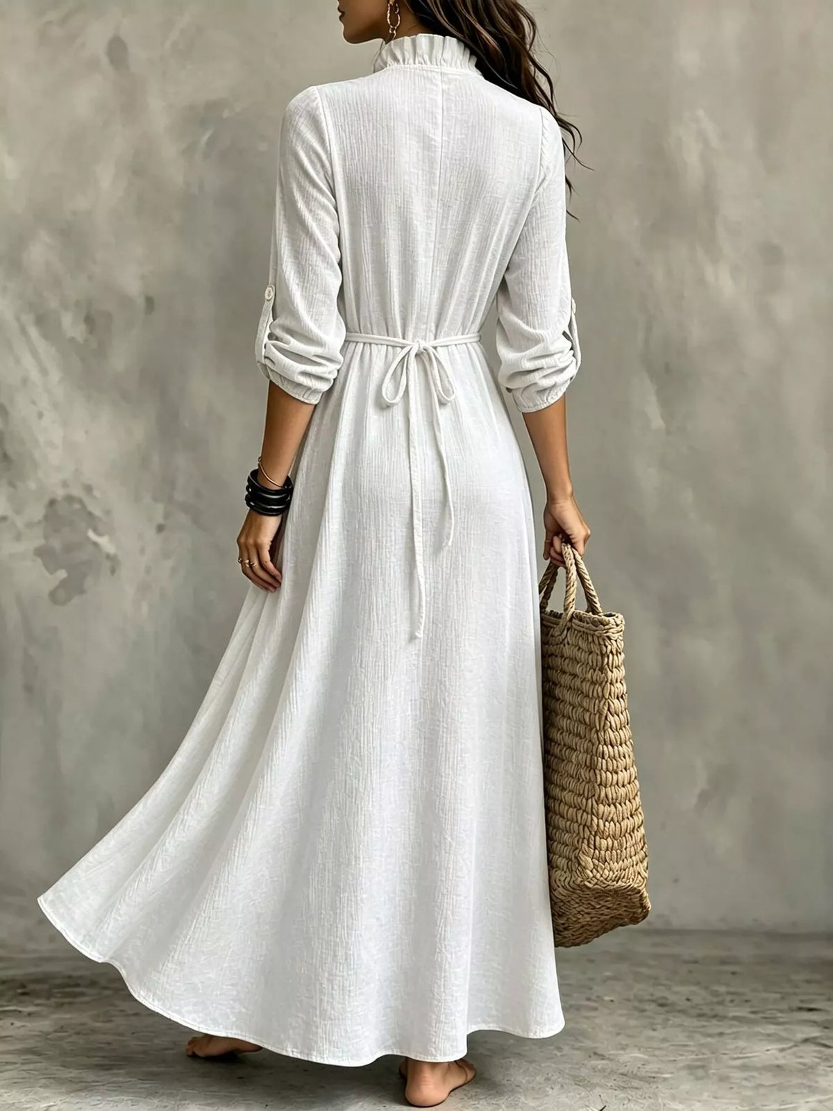 White maxi dress, 3/4 sleeves, tie waist at back and flowing skirt