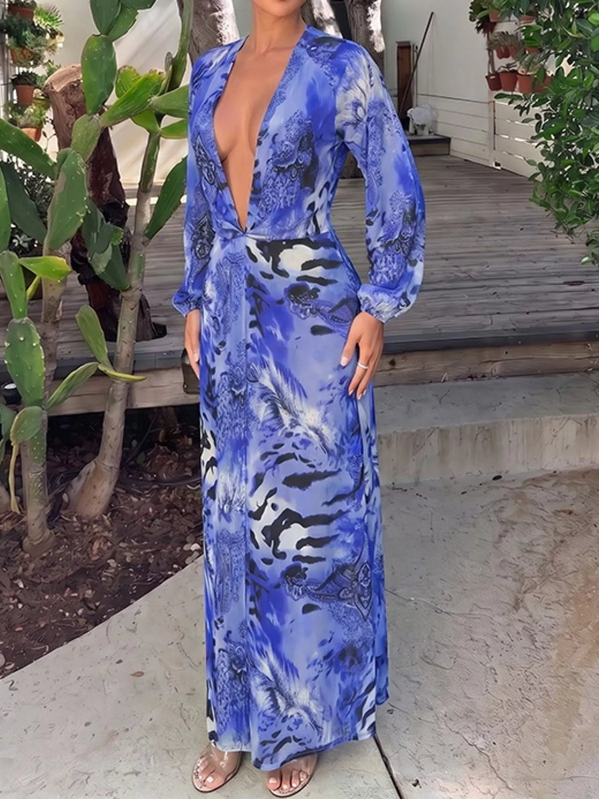 Blue printed maxi dress with deep V-neck, long sleeves, and flowing skirt